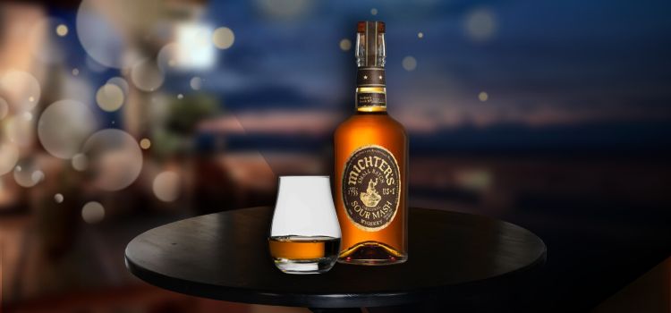 whiskey dram glass on desk with michter's