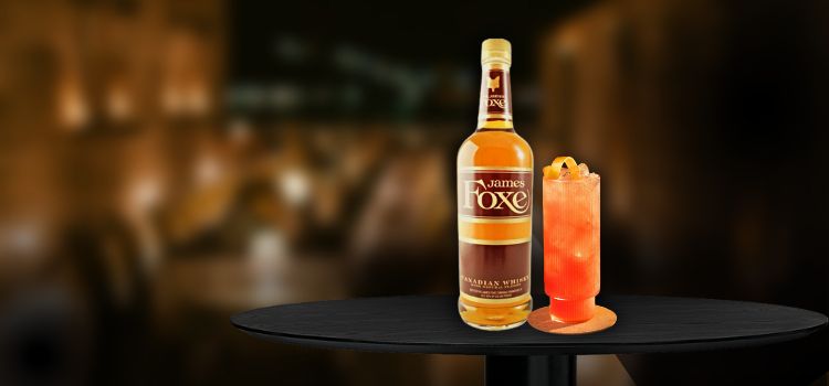 James Foxe on desk with cocktail