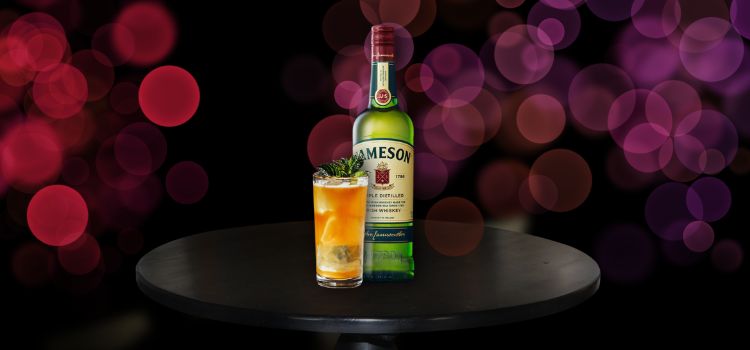 Jameson Irish Whiskey on table with cocktail