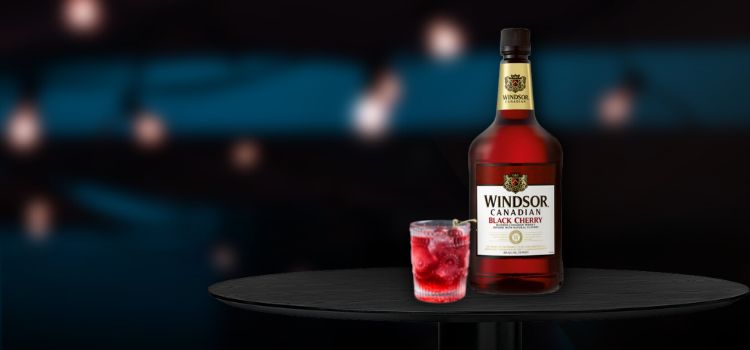 Windsor Canadian Whisky on desk with cherry cocktail
