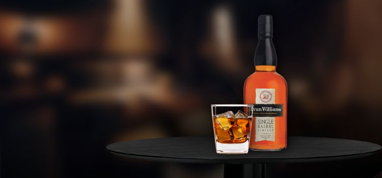 Evan Williams Single Barrel on desk with glass