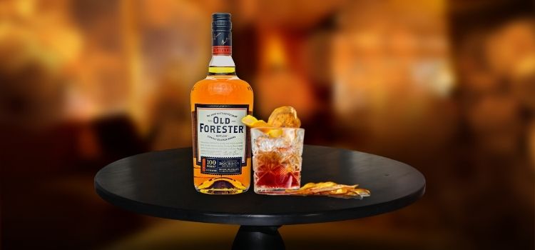 Old Forester 100 on desk with old fashioned glass, Best Bourbon for Old Fashioned