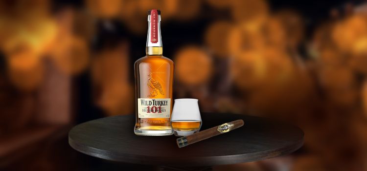 Wild Turkey 101 with glass and cigar on desk