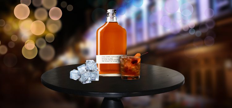 Kings County Bottled-In-Bond Bourbon Bottle and Cocktail Glass Drink and Ice