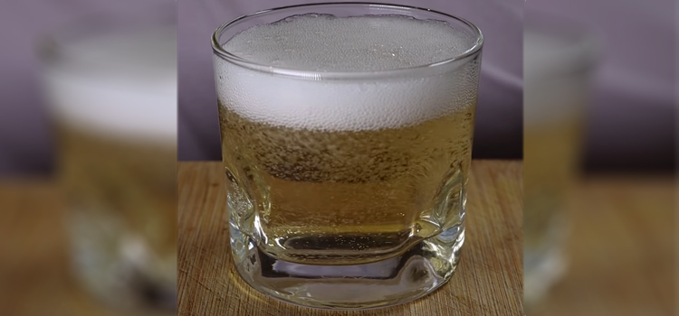 Glass of Ginger Ale on top of Wooden Table