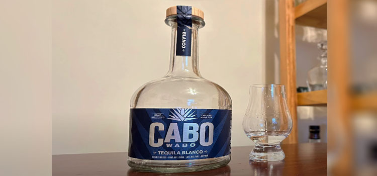 Bottle and a Glass of Cabo Wabo Tequila Blanco on a Table