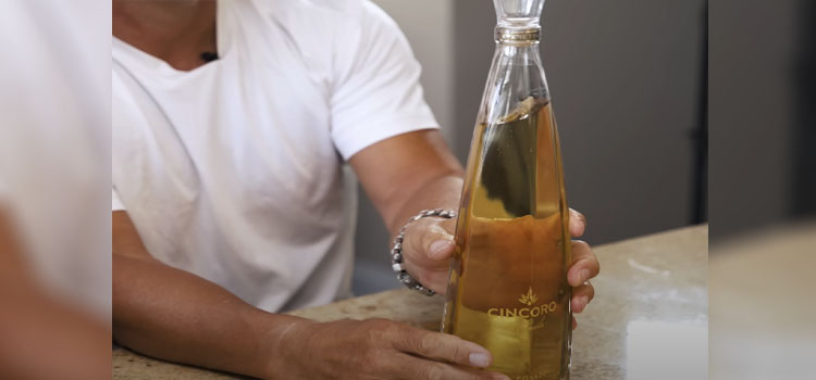 Man Holding Bottle of Cincoro