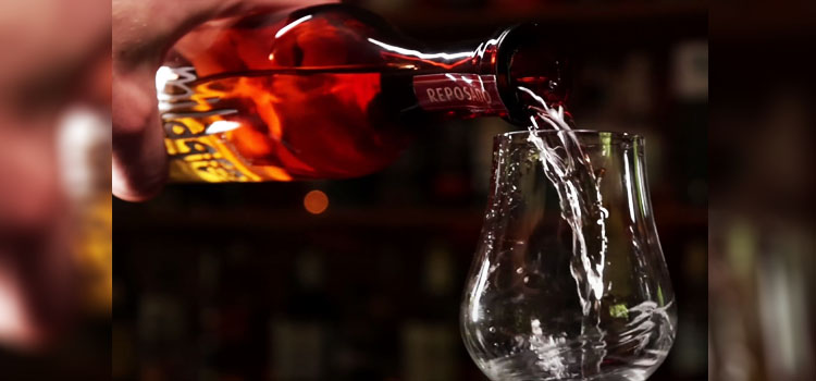 Pouring Bottle of Milagro Reposado on a Glass