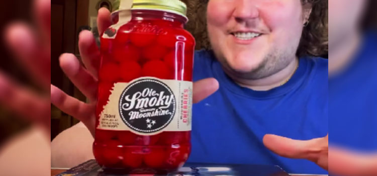Person Holding Jar of Ole Smoky Moonshine Cherries